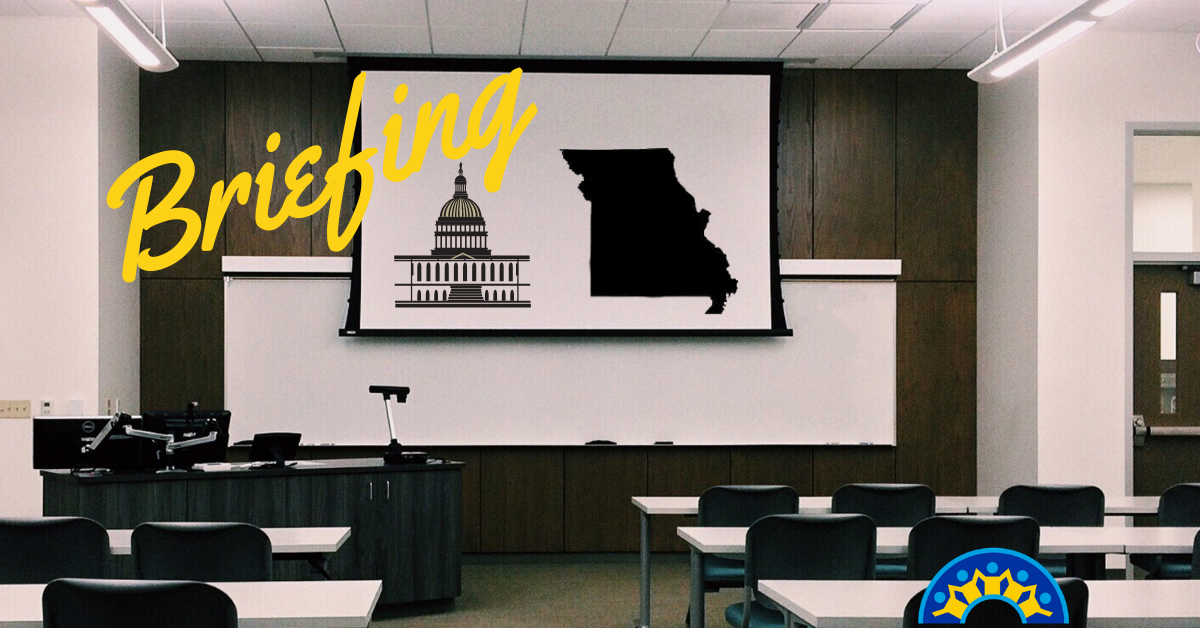 Classroom with white screen displaying a black silhouette of the state of Missouri and an outline of a capitol building.